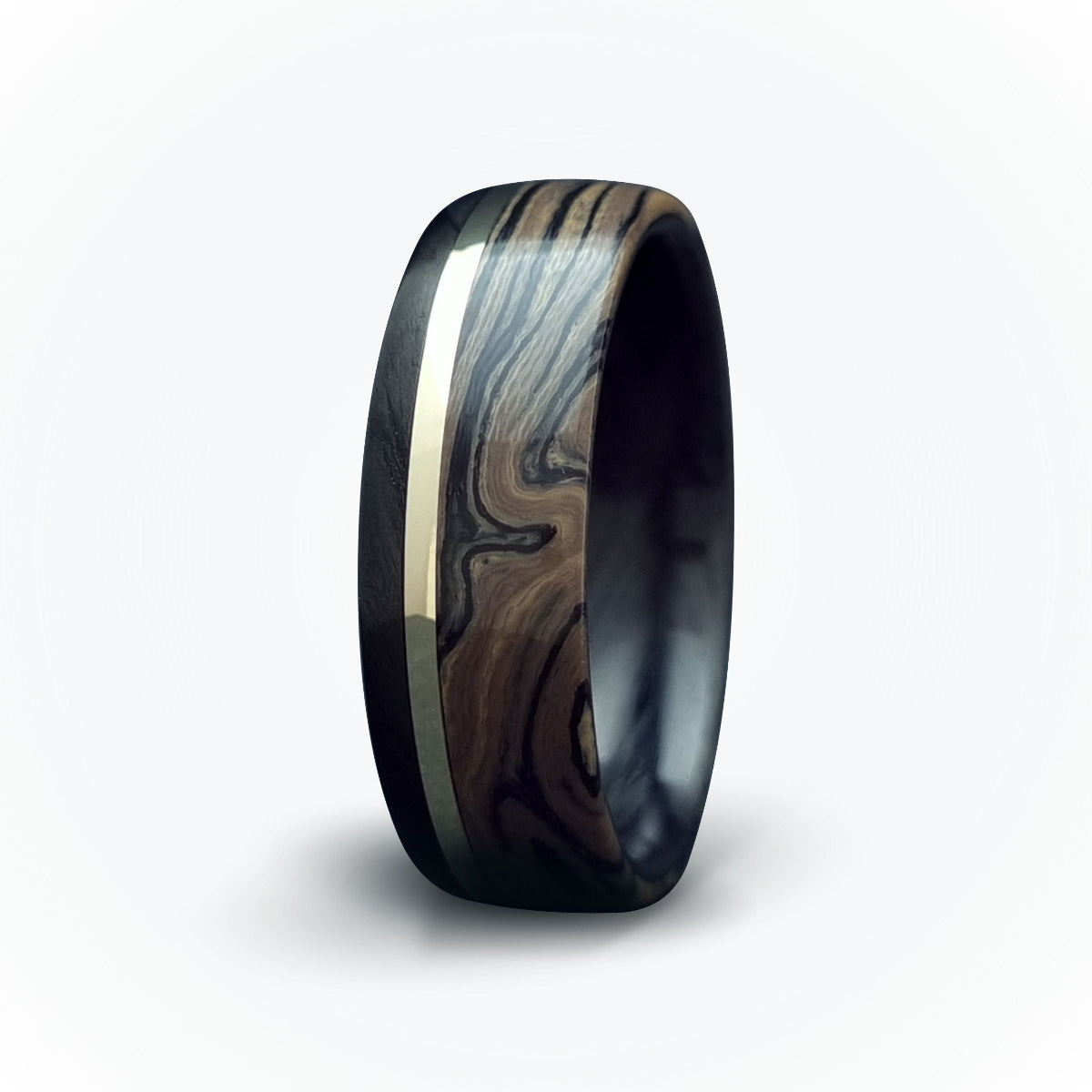 A men's carbon fiber ring with a gold inlay band and a textured black carbon fiber ring surface.