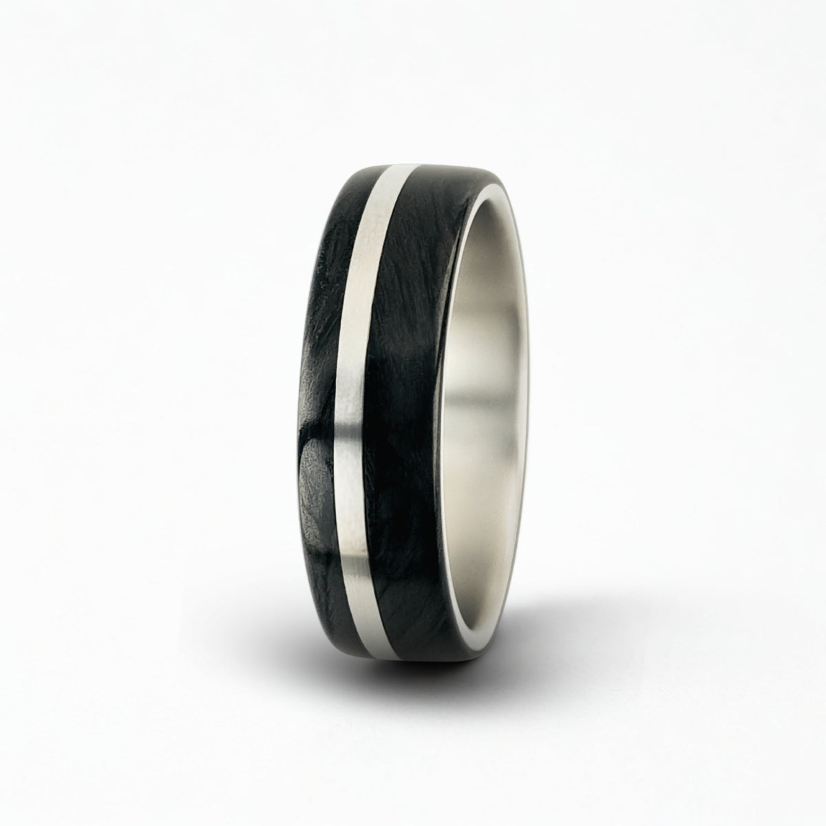 Silver, centre rail titanium ring with dual carbon fibre sleeves on a white background
