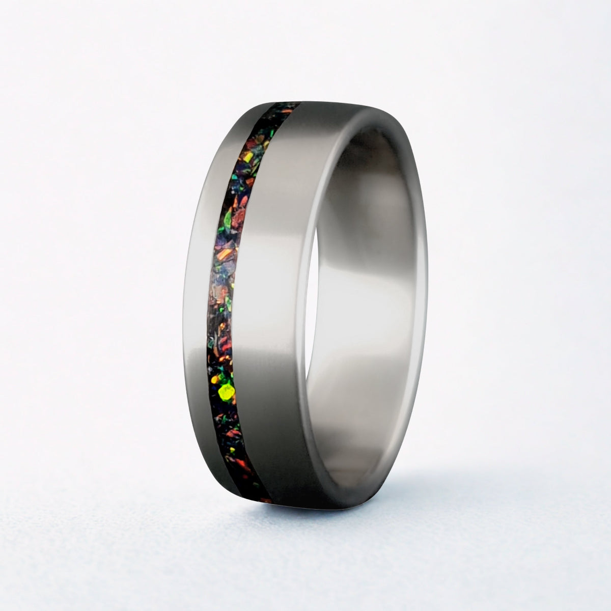 Silver ring with a colorful inlay on a white background