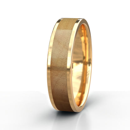 Gold ring with a textured band on a white background